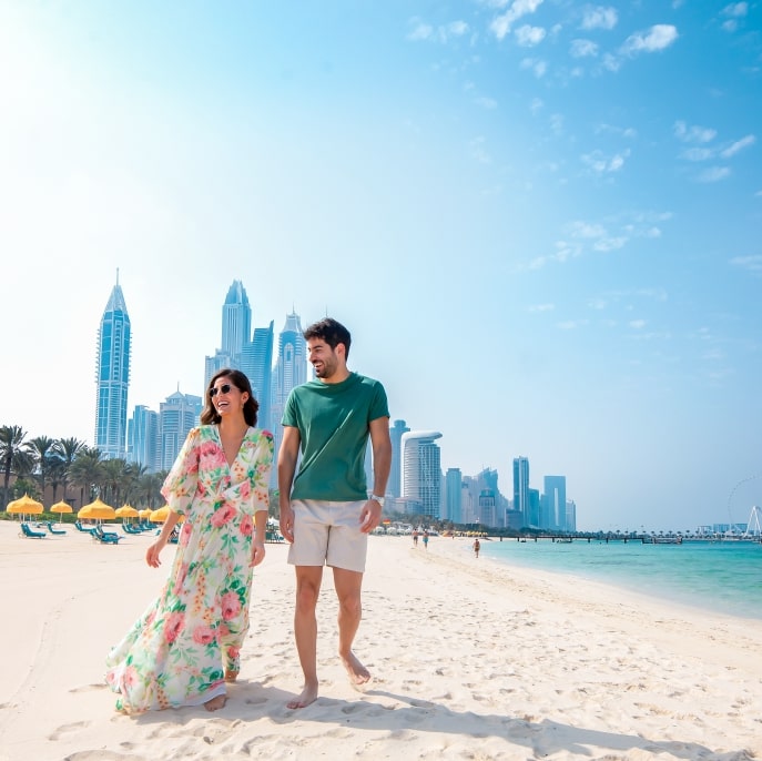 Couple walking along Jumeirah Beach