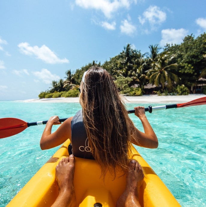 Couple kayaking in the Maldives