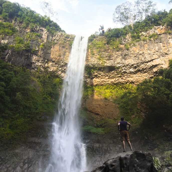 Man hiking to a water fall in the Mauritius